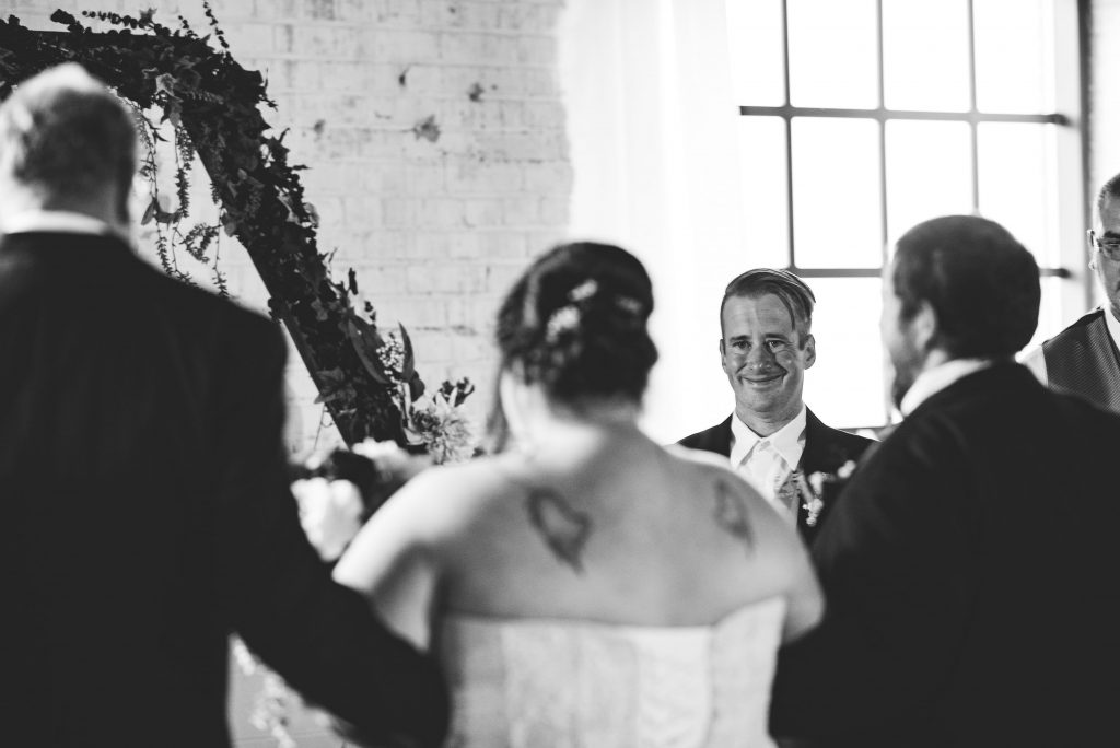 downt the aisle, groom seeing bride, first look, wedding ceremony, the brick, wedding at the brick, south bend wedding photographer, south bend wedding venue, candid wedding photos,