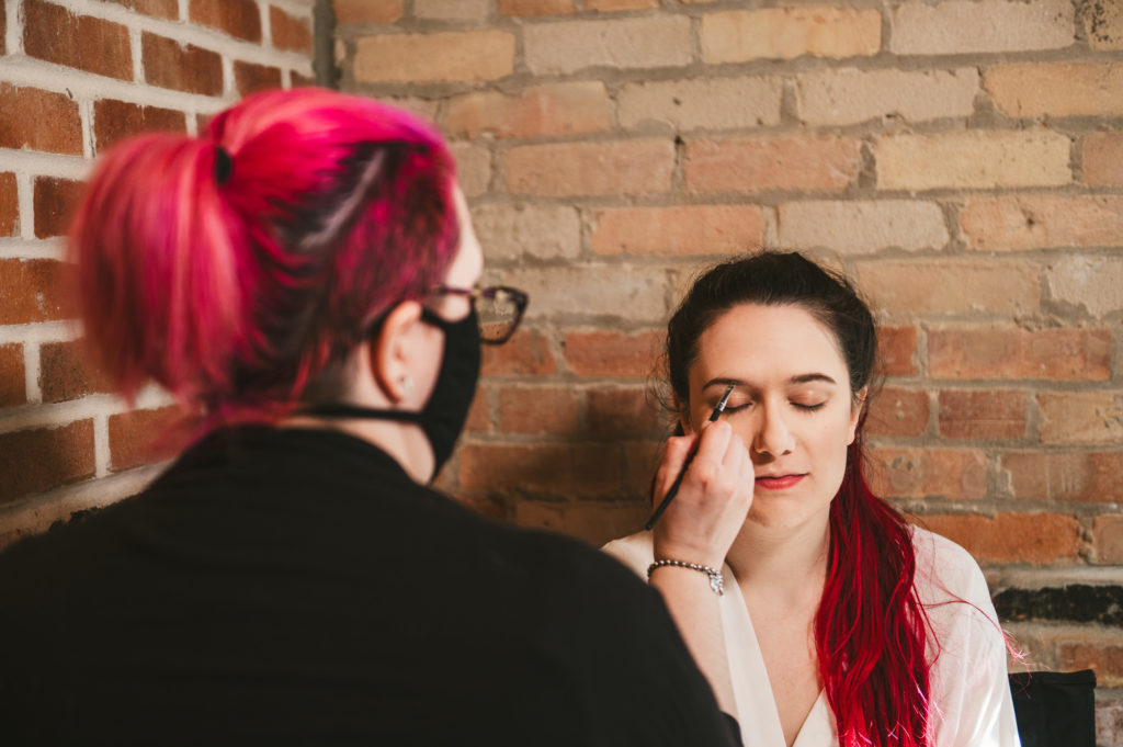 makeup by Keria doing makeup on bride Westley Leon Studios Wedding Photography Barrelhouse at Zorn in Michigan City