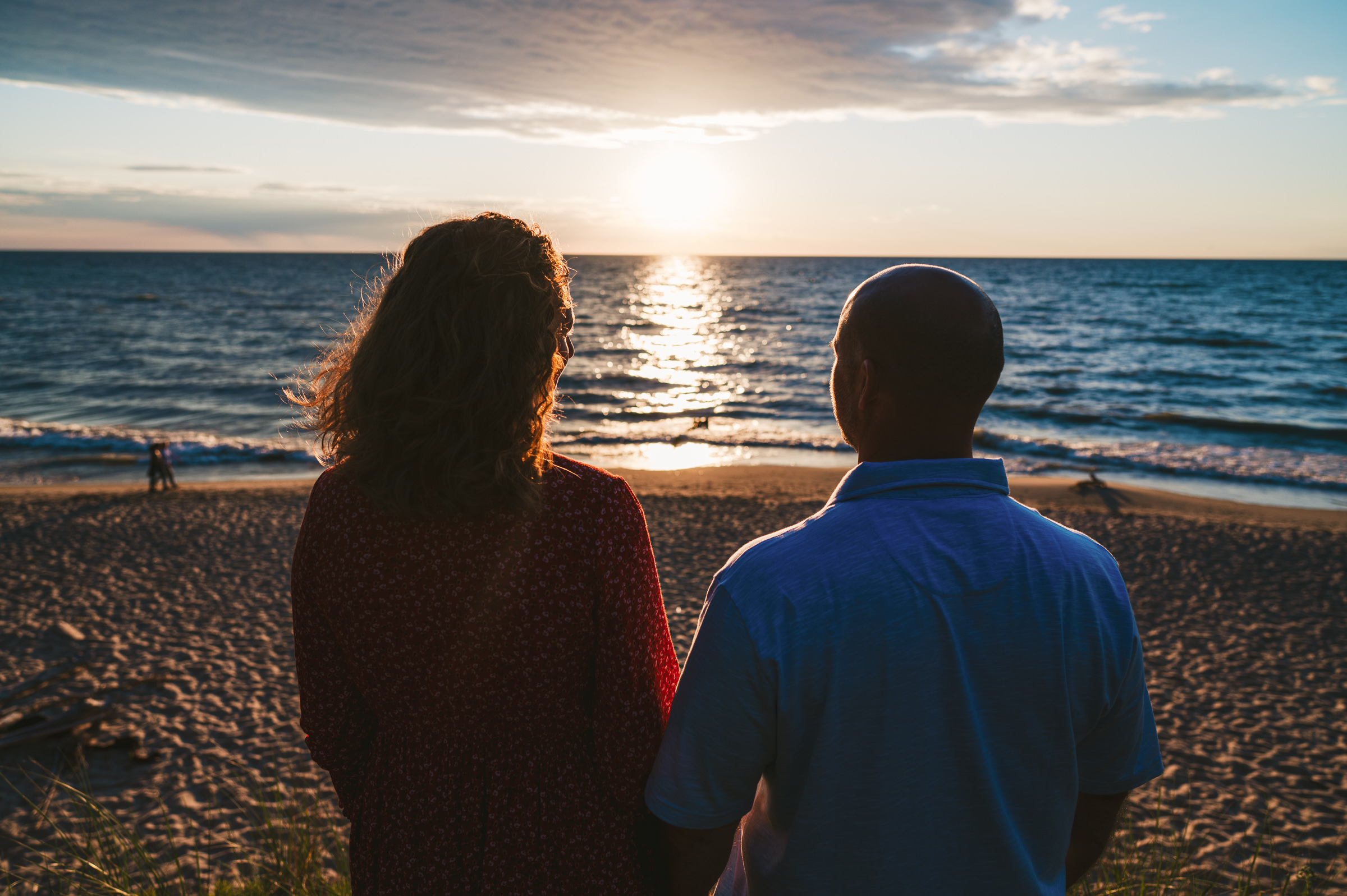 couple staring off into the sunset on the beach Westley Leon Studios at Rocky Gap Beach in St Joseph Michigan