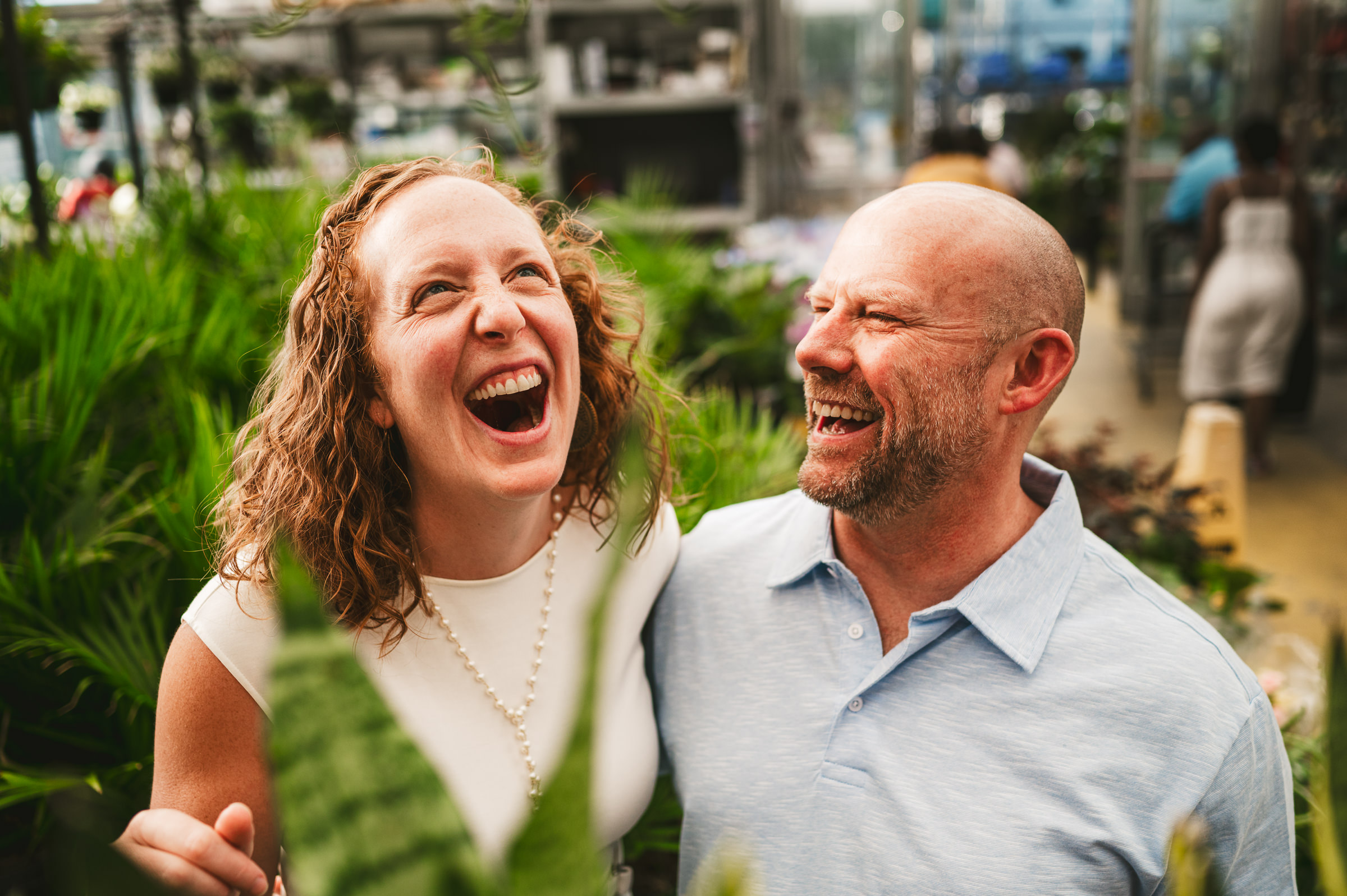 couple laughing in the plants section Westley Leon Studios Wedding Photographer Lowe's Home Improvement in Mishawaka Indiana