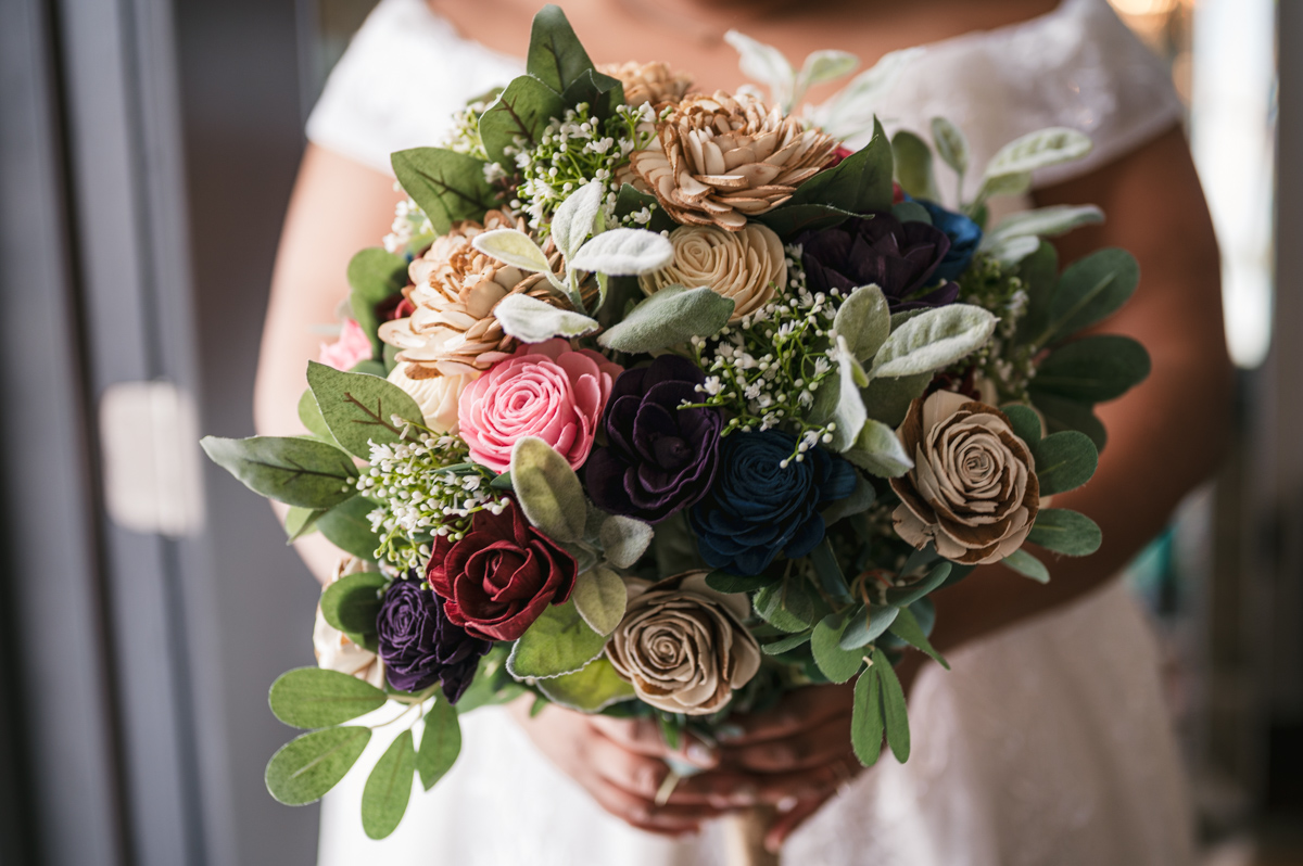 close up of bride holding wedding bouquet